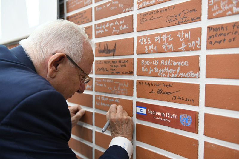President Reuven Rivlin on July 17, 2019, signing a brick in the wall at the Korean Demilitarized Zone between South and North Korea, which is signed by all world leaders who visit. The name of his late wife, Nechama Rivlin, is written on the next brick.