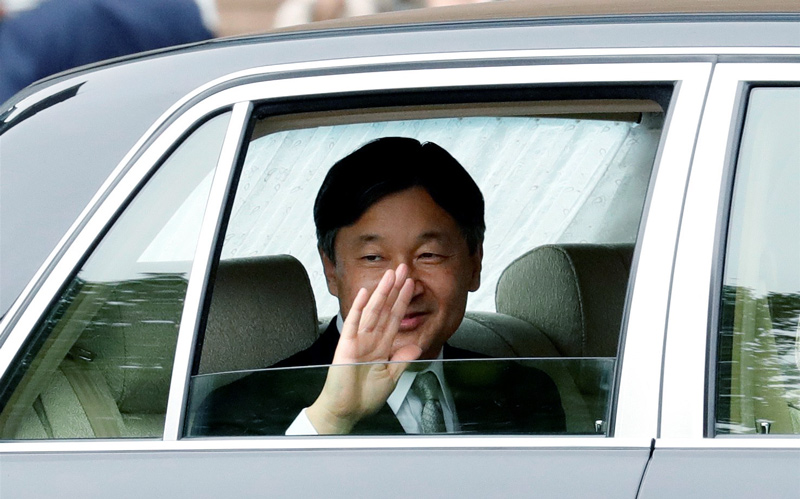 Japan's new Emperor Naruhito waves as he arrives at the Imperial Palace in Tokyo, Japan on May 1, 2019.