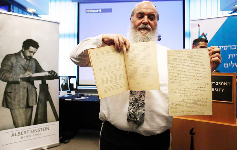 Roni Grosz, the curator of the Albert Einstein Archives at the Hebrew University in Jerusalem, shows the original documents written by Einstein related to his prediction of the existence of gravitational waves.