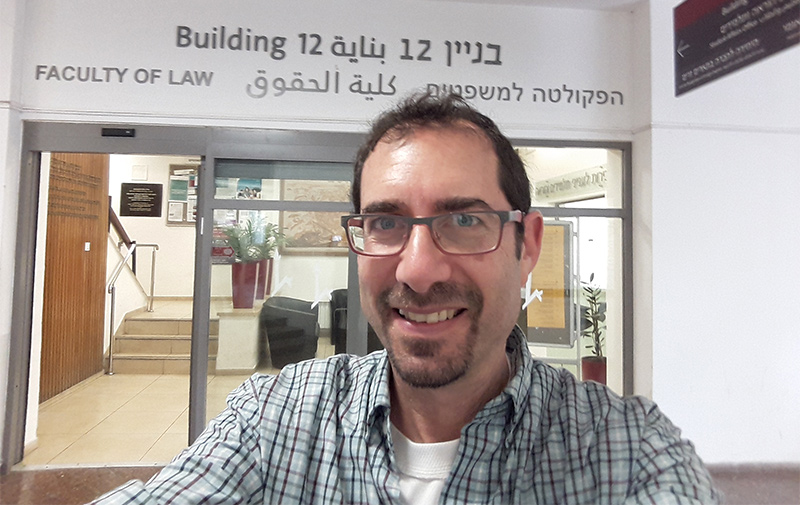 Isaac Becker in front of the Faculty of Law