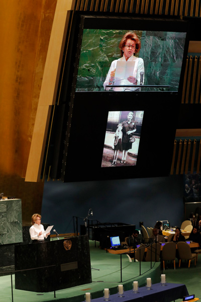 Holocaust survivor Irene Shashar speaks while a photo of herself and her mother is displayed during a Holocaust memorial event at U.N. headquarters, Monday, January 27, 2020.