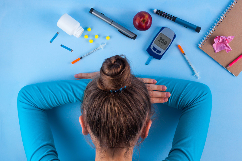 Woman with diabetes medication and glucose meter