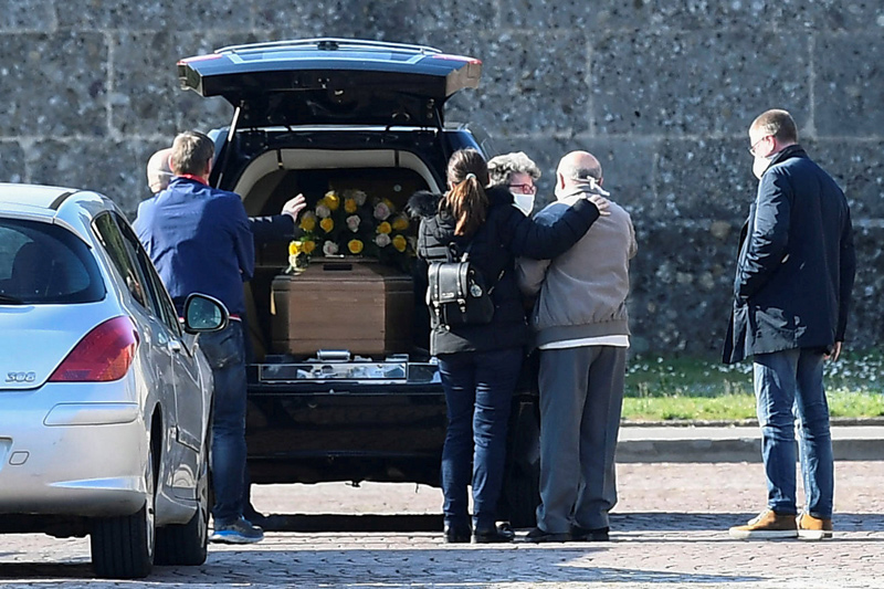 Relatives of a person who died from coronavirus disease (COVID-19) arrive at a cemetery in Bergamo, Italy March 16, 2020.