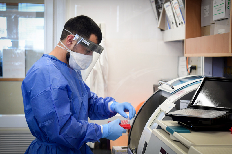 Medical team members at the Barzilay hospital, in the southern Israeli city of Ashkelon, wear protective gear, as they handle a coronavirus test sample on March 29, 2020.