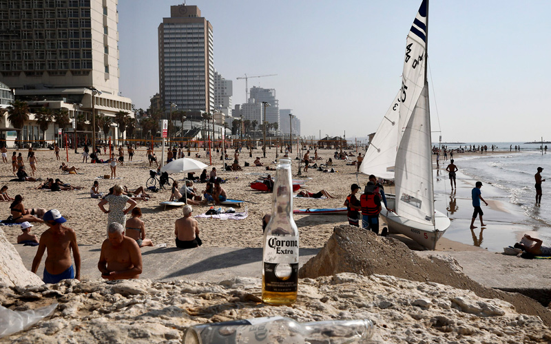 Israelis enjoy the beach in Tel Aviv, March 16, 2020.