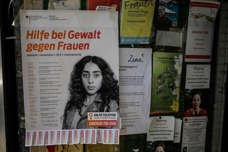 A poster at the entrance to a shop advertises the number for a helpline for women targeted by violence during the coronavirus pandemic. Berlin, April 7, 2020.