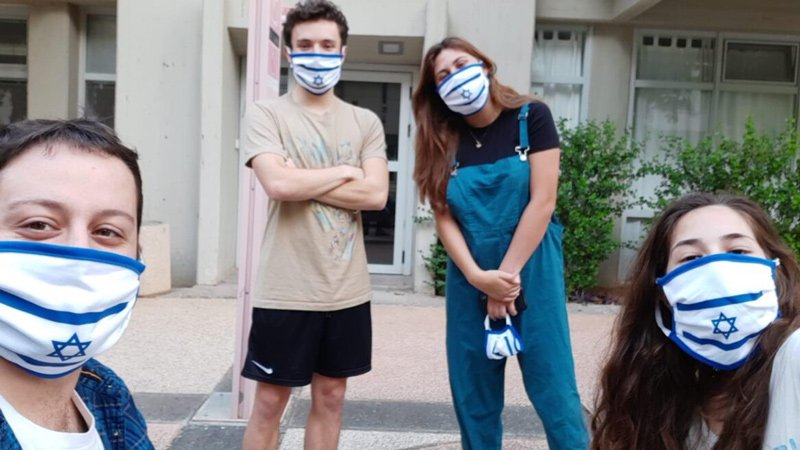 International students sporting the facemasks they received on Independence Day in May.