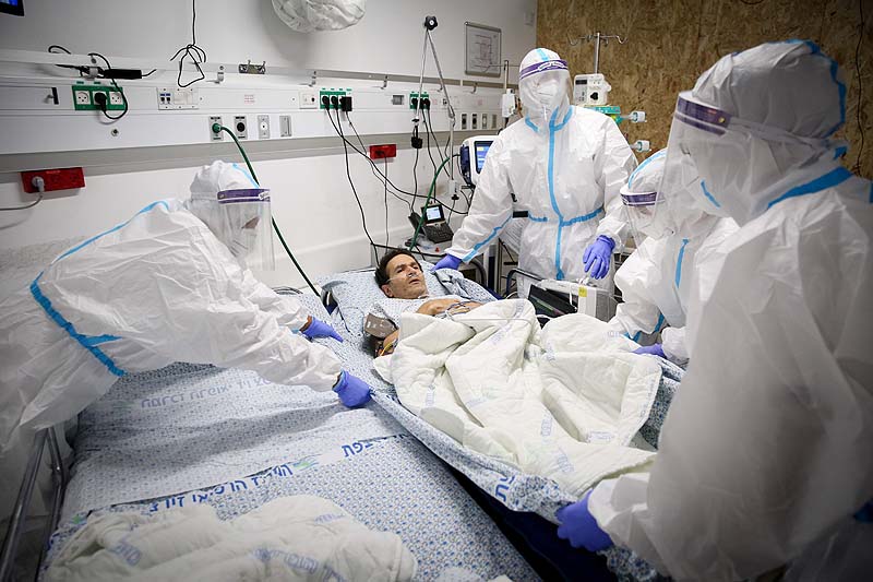 Medical staff examine a mock coronavirus patient during an exercise simulating the treatment of coronavirus patients, at the coronavirus critical care unit, at the Ziv Medical Center in Safed on July 9, 2020.