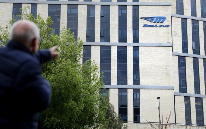 A man walks past the logo of Israeli car tech firm Mobileye on the company’s offices in Jerusalem.