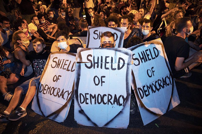 Protesters block a main road during a protest against Israel's Prime Minister Benjamin Netanyahu outside his official residence in Jerusalem, early Sunday, Aug 2, 2020. Protesters demanded that the embattled Israeli leader resign as he faces a trial on corruption charges and grapples with a deepening coronavirus crisis.