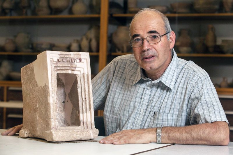 Yosef Garfinkel with a shrine model made of stone, found at Hirbet Qeiyafa.