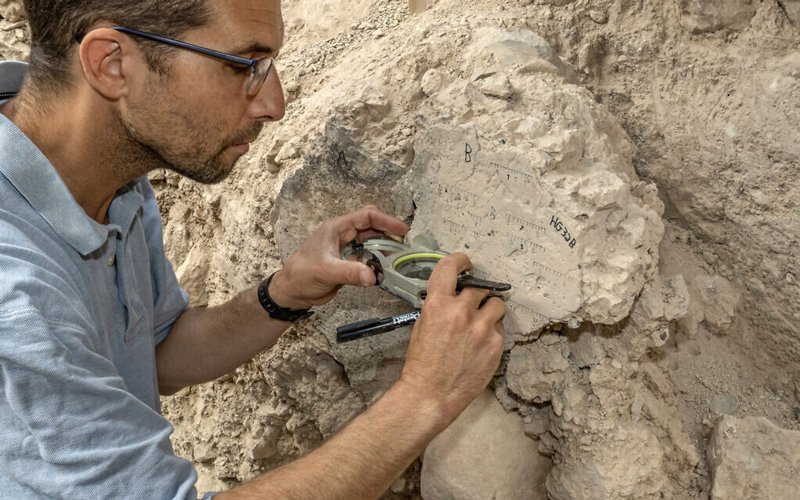 TAU PhD student Yoav Vaknin takes measurements of a floor that collapsed during the 586 BCE destruction of Jerusalem by the Babylonians at excavations in the City of David Park in Jerusalem.