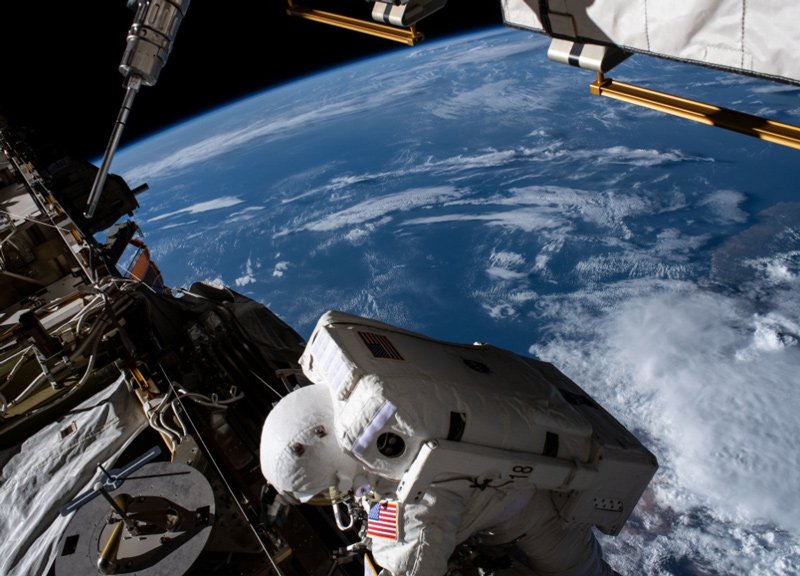 Illustrative: NASA astronaut Jessica Meir on a spacewalk outside the ISS, with the earth in the background.
