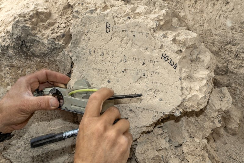 TAU PhD student Yoav Vaknin takes measurements of a floor that collapsed during the 586 BCE destruction of Jerusalem by the Babylonians at excavations in the City of David Park in Jerusalem.