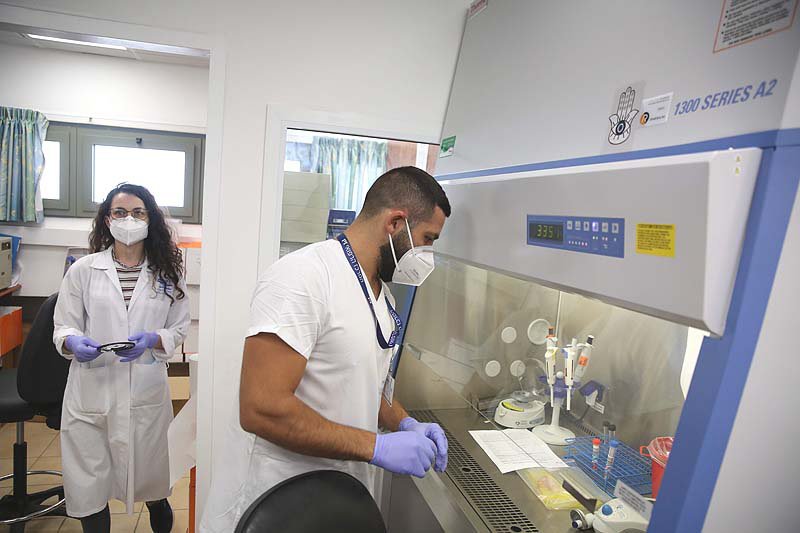 A technician carries out a diagnostic test for coronavirus in a lab in Tzfat, August 24, 2020.