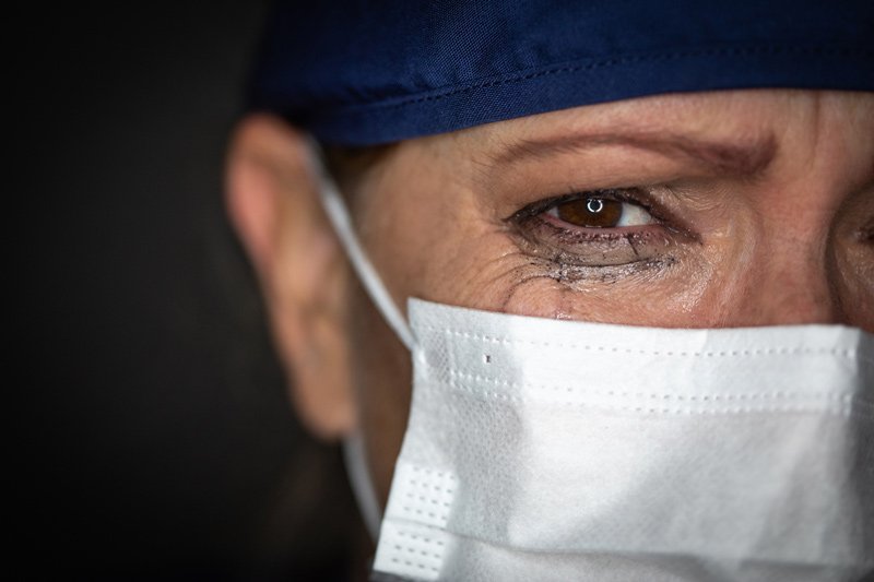 A medical professional sheds a tear over the human cost of the pandemic.