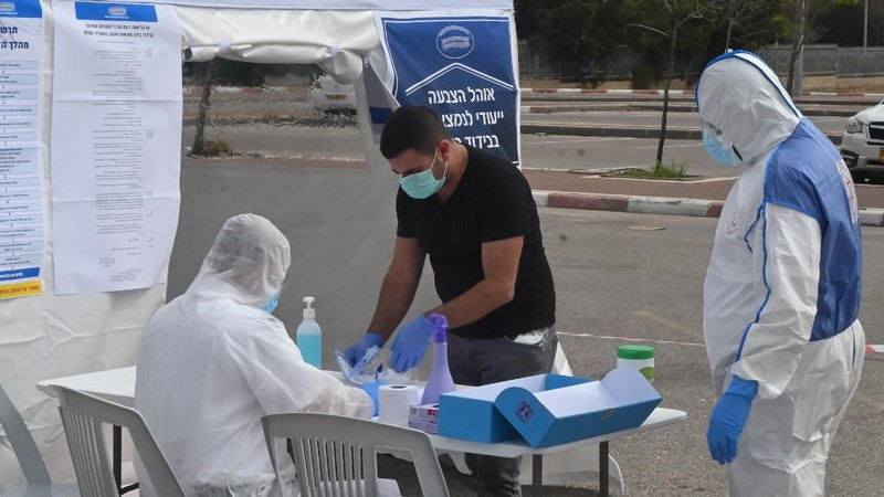 An Israeli in quarantine casts his ballot at a pop-up polling station in Ashkelon in the March 2020 elections.
