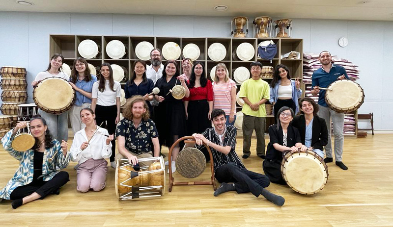 Students of Hebrew University's Korean studies pose with traditional Korean instruments during a samulnori (traditional percussion music) workshop as part of their seminar trip to Korea in August. Lyan is second from right in the front row. Courtesy of Irina Lyan